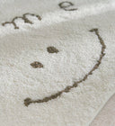 Clement Smiley Face Plush Accent Rug - Neutral Tones, Lofted Plush Pile with a Coated Grip Backing, Soft Bedside Mat