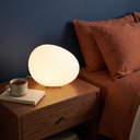 Solene cobblestone night light glowing warm white on a bedroom nightstand