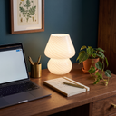 Lennox white LED mushroom lamp lit on a walnut home office desk