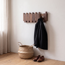 Corbin coat rack with a coat hanging from one pivoted-out batten