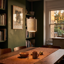 Rhea travertine pendant in dark wood over a dining table
