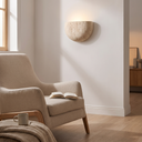 Emory stone wall lamp beside a reading chair