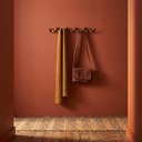 Bram wave wall coat rack in a warm hallway, to scale