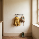 Bram three-hook wave wall coat rack in a family mudroom