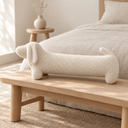 Dachshund Shaped Plush Bolster Pillow in White styled in a bedroom